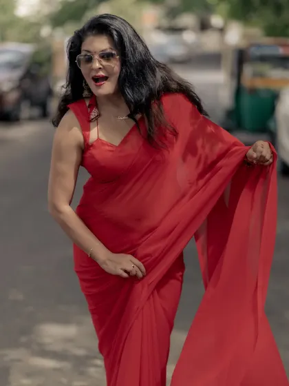 A plain red saree doesn't have to be boring. I styled this look with a modern blouse and sunglasses to give it a bold, carefree attitude, perfect for an outdoor event.
