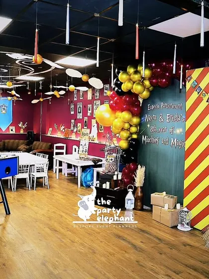 This overview of the Harry Potter party room shows how all the elements came together: the themed backdrops, ceiling decorations, house banners, and activity tables, creating a completely immersive experience.