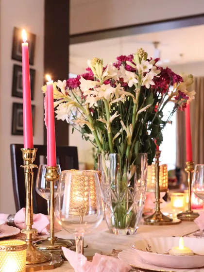 Diwali table decor, featuring fresh flowers and glowing candles.