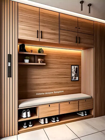 This floor-to-ceiling entryway storage unit is crafted from warm wood. It features a seating bench with drawers, shoe cubbies, and overhead cabinets for maximum organization.