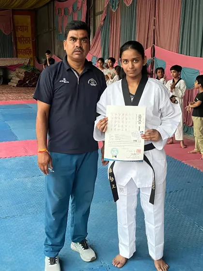 Vanshika Singhal proudly holds her black belt certificate. She is a testament to what hard work can achieve.
