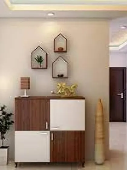 A minimalist foyer setup with a compact two-tone shoe cabinet and decorative house-shaped wall shelves. This is a great solution for smaller entryways.