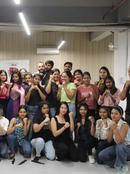 This is the result of a successful workshop: a group of empowered women, confident and ready. We end the session with a warrior's pose, symbolizing their newfound strength and the supportive community we build together.
