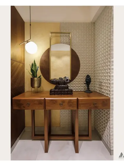 A full view of the foyer design. The space combines multiple textures, including carved wood panels, a 3D geometric wall, and smooth finishes, to create a rich and layered look.
