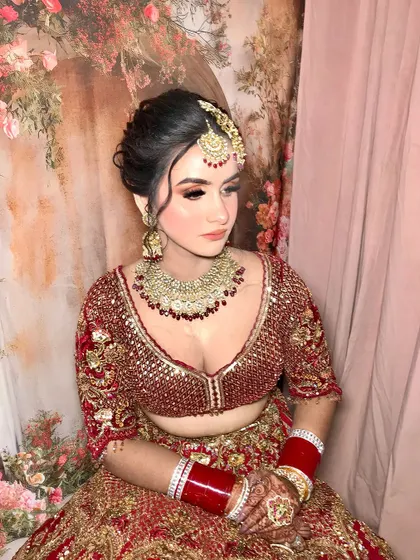 A beautiful portrait of my bride in her red and gold lehenga. The coral tones in her makeup add a fresh, modern twist to the traditional look.