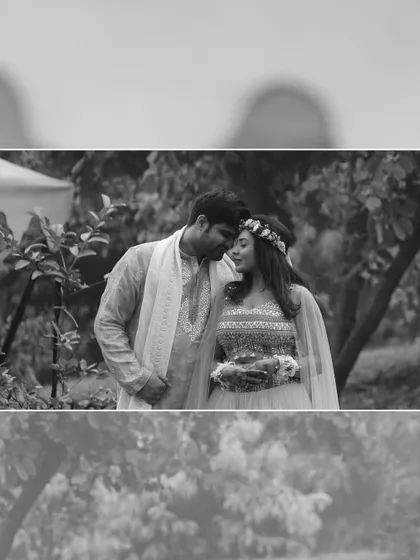 A timeless black and white portrait of the couple in a quiet garden moment, emphasizing the emotion and connection between them.