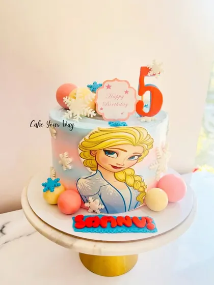 Another Elsa-approved cake for a 5th birthday, this time with a beautiful character print and pastel-colored chocolate spheres.