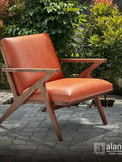 Our 'Cabo' chair, crafted from seasoned European ash wood and upholstered in rich, tan art leather. The angular, Z-shaped frame makes it a modern design statement for any room or covered patio.