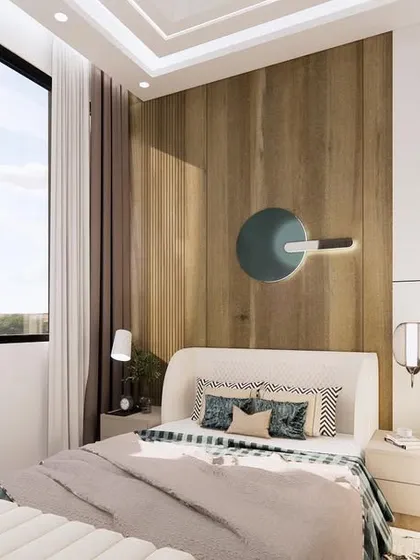 This view of the guest bedroom highlights the use of wood paneling and a unique wall-mounted lamp. The design is simple yet sophisticated, creating a comfortable and welcoming space for visitors.