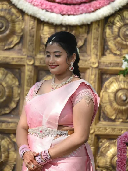 A close-up of the engagement look, showing the delicate maang tikka, simple necklace, and the soft, natural-looking makeup.