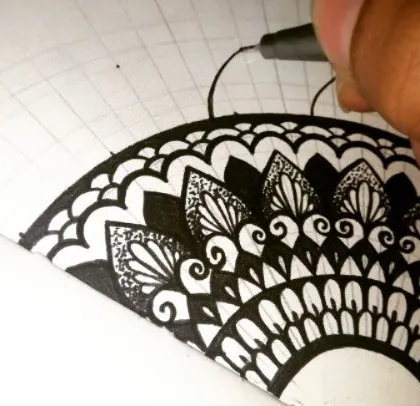 A work-in-progress shot of a half-mandala. You can see the grid I use to keep the pattern symmetrical as I build it outwards.