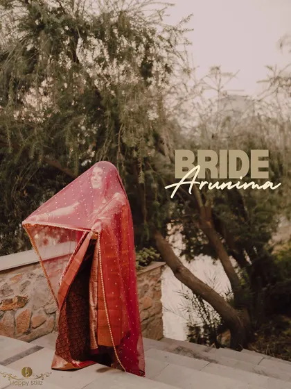 An artistic portrait of the Bengali bride, with her name elegantly written. Her traditional saree and veil are beautifully captured against a natural backdrop.