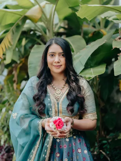 A beautiful portrait of the bride holding flowers. Her makeup is kept minimal and fresh to let her natural beauty shine.