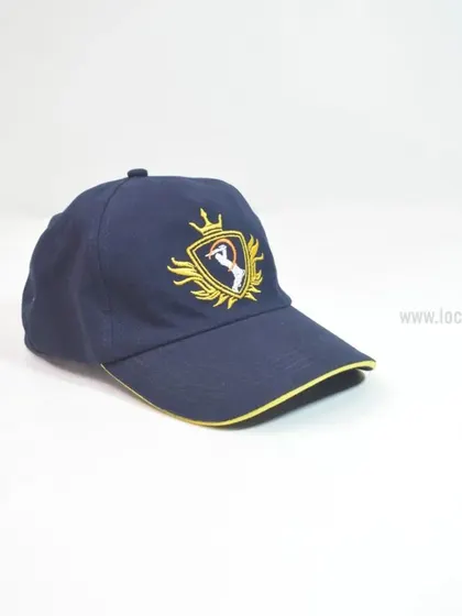 A close-up of a navy blue baseball cap with intricate gold and white embroidery. This highlights the premium look and feel of our embroidered logos, perfect for making a strong brand statement.