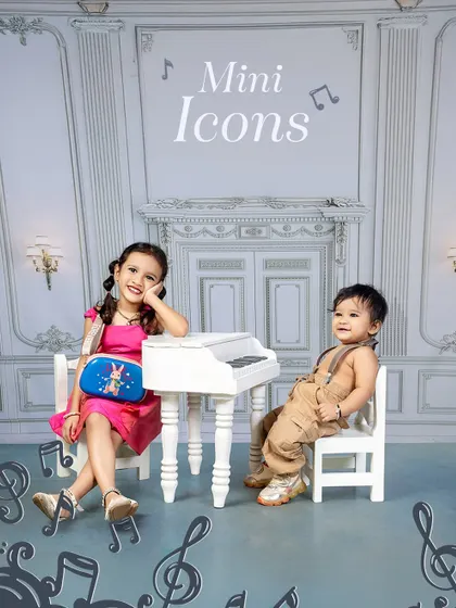Mini Icons making the biggest statements. This photo of a sister and brother at a miniature piano is a fun and stylish way to capture their sibling dynamic.