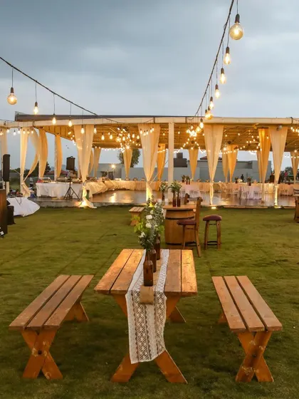 We believe in creative and sustainable decor. For this rustic Mehendi, we upcycled beer bottles into charming flower vases and used a boat as a unique centerpiece, all under a canopy of poetic string lights.