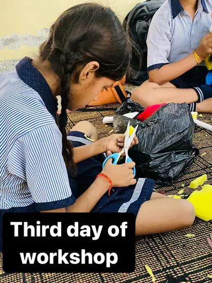 A student carefully cuts material for her puppet on the third day of our school workshop. Every step is done by hand.