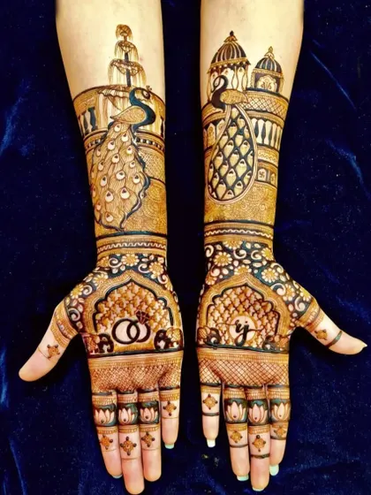 A unique design with peacocks and palace architecture on the arms, and wedding rings and a proposal silhouette on the palms.