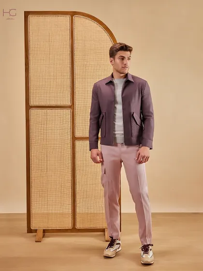 Move beyond the basics with elevated hues for the season. This look pairs a deep maroon shacket with muted pink trousers, showcasing a confident use of color in contemporary menswear.