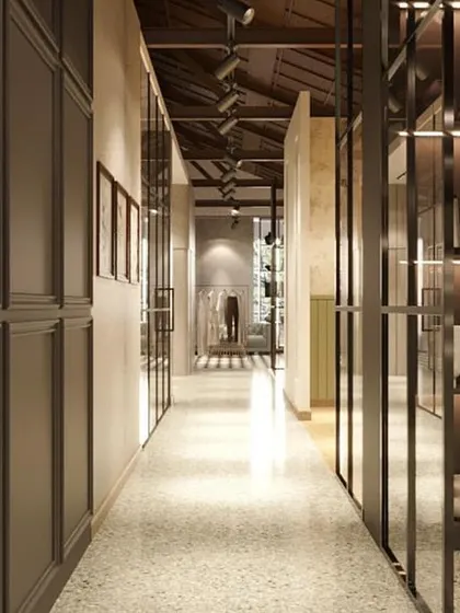 This rendering shows a hallway connecting different "rooms" within the store. The paneled walls and glass partitions guide the customer journey while offering glimpses of the spaces ahead.