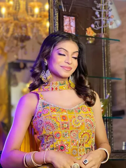A final shot of the airbrush makeup demo, with the model's eyes closed to showcase the soft blending on the eyelids. The overall look is polished, clean, and elegant.