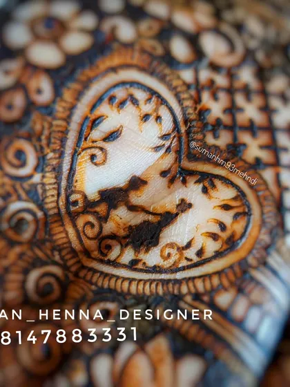 A macro shot of a custom heart motif, showing the fine lines and details that go into creating personalized symbols within a larger bridal design.