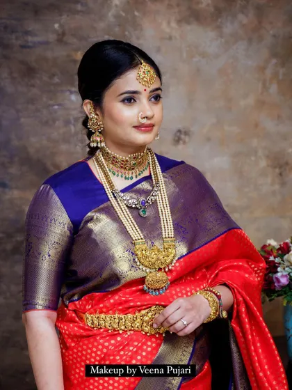 A close-up of the vintage look, showing the detail of the pearl and gold jewelry and the soft, elegant makeup.