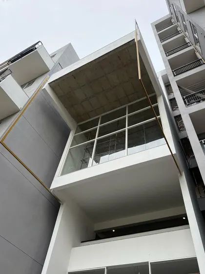 The glass-enclosed squash court at the 'Treehouse' is part of the vertically stacked social core. It activates the central volume of the building, making recreation a visible and integrated part of the community.