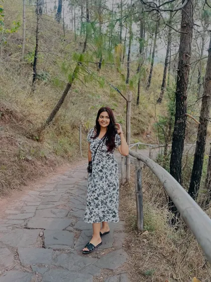 Walking along a stone path in the woods. This floral dress and simple black slides are perfect for a nature walk.