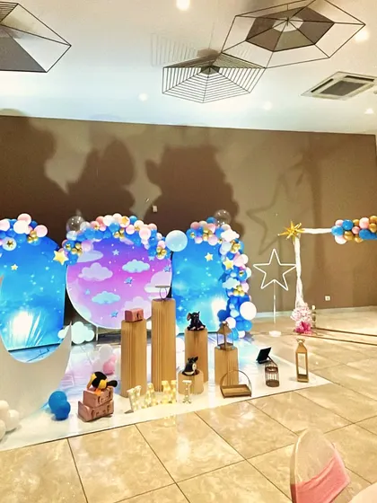 A wide-angle view of the 'Star and Moon' party decor, showing how the setup is arranged within the event hall.