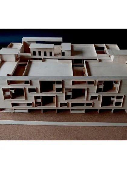 An overhead view of the school model reveals the complex network of rooftop terraces and light wells that bring daylight deep into the building.