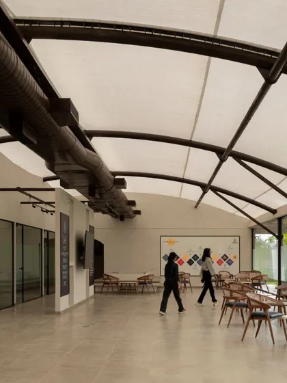 The main hall of the Brigade Oasis office has a high, curved ceiling with an exposed tensile fabric roof, creating a large, open, and airy space.