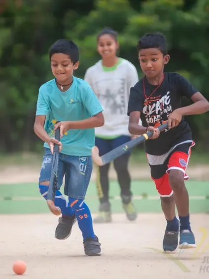 The excitement of the chase. Two young boys from our 2022 camp having fun while learning the game.