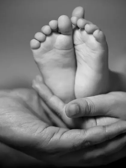 A little bit of heaven held in your hands. This black and white photo of tiny feet is a timeless keepsake.