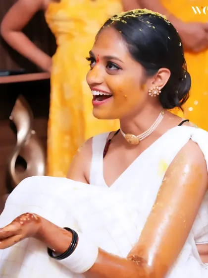 A candid shot of the bride's infectious laughter during her Haldi. These are the unposed, genuine moments that truly tell the story of your wedding day.