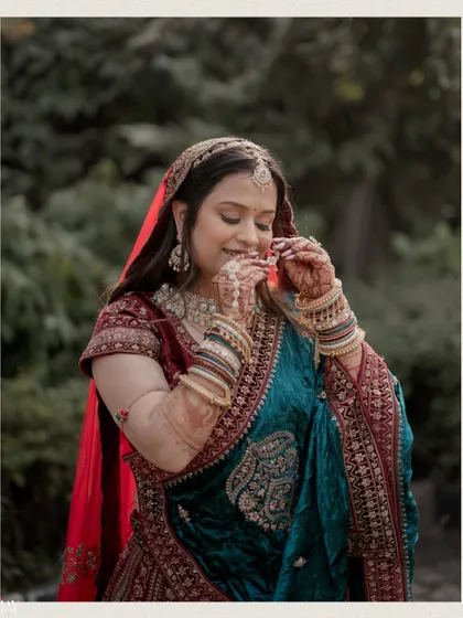 A close-up of the bride, her smile and the details of her traditional lehenga shining through.