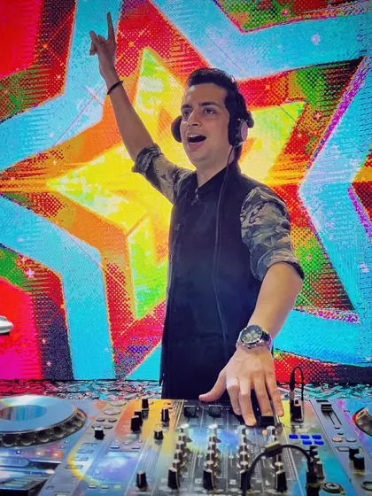 The energy is palpable as I command the stage in front of a vibrant, psychedelic LED wall. This is me in my element, bringing a high-voltage performance to a packed house.
