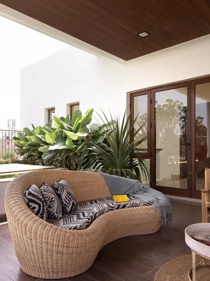 A cozy seating area on the terrace, perfect for relaxing and enjoying the outdoors. The wooden deck and ceiling add warmth to the space.