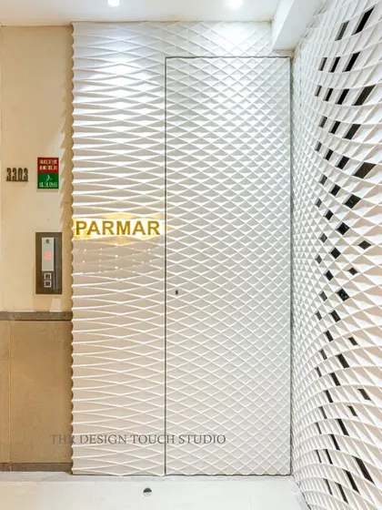 From another angle, you can see how the textured Corian wall panels wrap around the corner, integrating the elevator area and creating a completely immersive and high-end entryway experience.