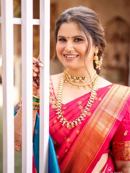 A happy, smiling portrait that truly captures her personality. The makeup enhances her features, giving her a confident and radiant glow.