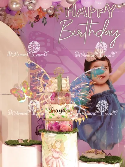A close-up of a beautiful fairy-themed cake, perfectly coordinated with the party's backdrop.