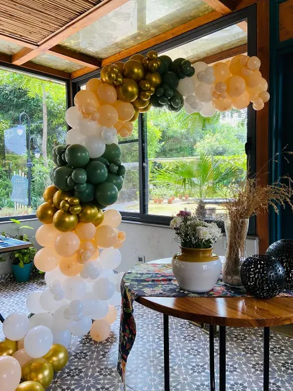 I also create balloon arches in unique color palettes, like this rustic combination of olive green, gold, peach, and white, perfect for a daytime event or a garden party.