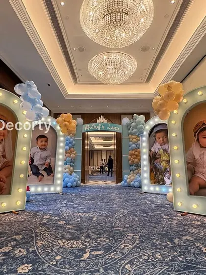 A wide shot of the grand photo entrance, showing how the illuminated frames create an impressive walkway into the party.