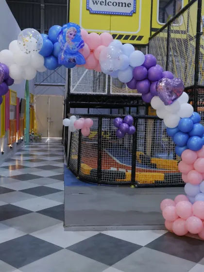 A magical entrance for a 'Frozen' themed birthday party. The balloon arch in shades of purple, blue, and pink sets the stage for an icy adventure.