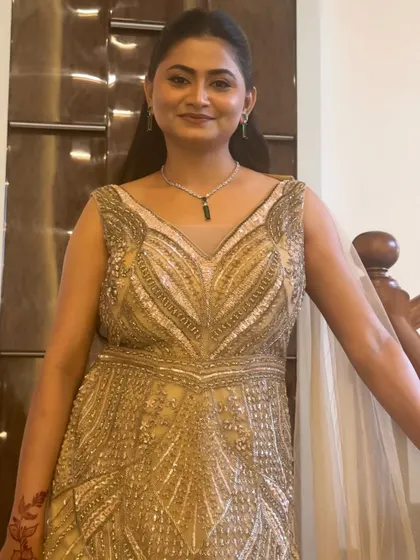 A full-length view of the client in her stunning beaded gown. The makeup is designed to be glamorous yet understated, completing her elegant ensemble.