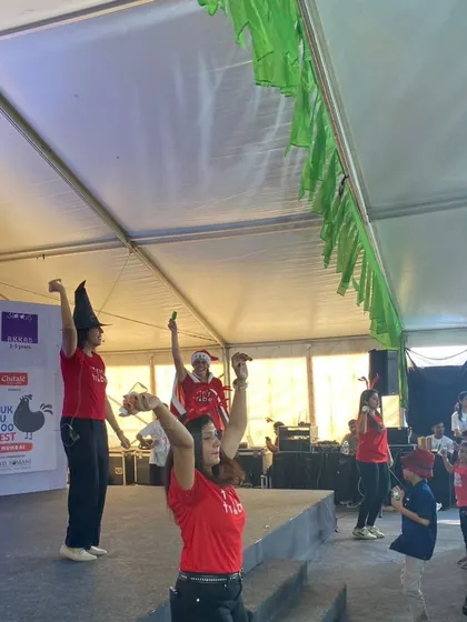 Our teachers leading the audience in a movement activity from the stage. Getting children and parents to move their bodies is a key part of our interactive performance style.