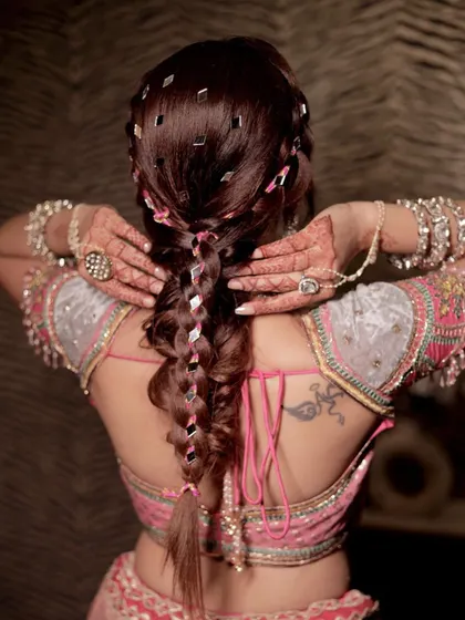 We love adding a bit of drama with accessories. This intricate braid with mirror work is perfect for a sangeet or cocktail party. Learn how to securely place these small details for a big impact.