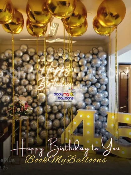 This 45th birthday was a shimmering spectacle of silver and gold. The decor featured a full wall covered in silver balloons, with gold balloons floating on the ceiling and large marquee numbers to mark the special occasion.