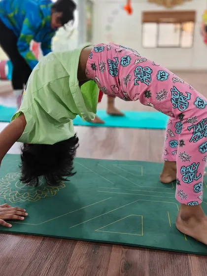 This is a wonderful Chakrasana, or Wheel Pose, which builds strength in the arms, legs, and spine. It's a powerful and energizing backbend that kids love to practice.