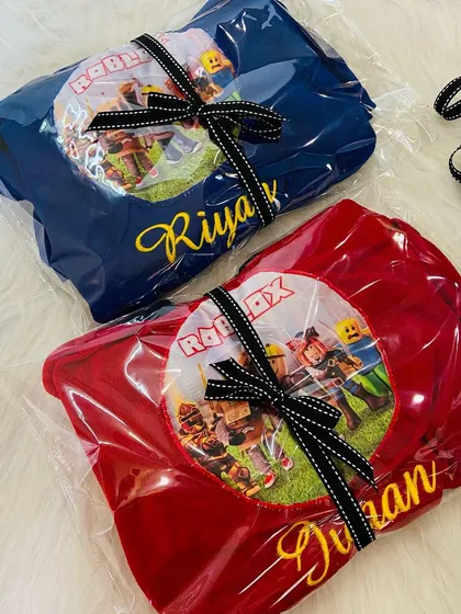 Our personalised Roblox bathrobes, all packed up and ready for a birthday party. They are a unique and cozy return gift.